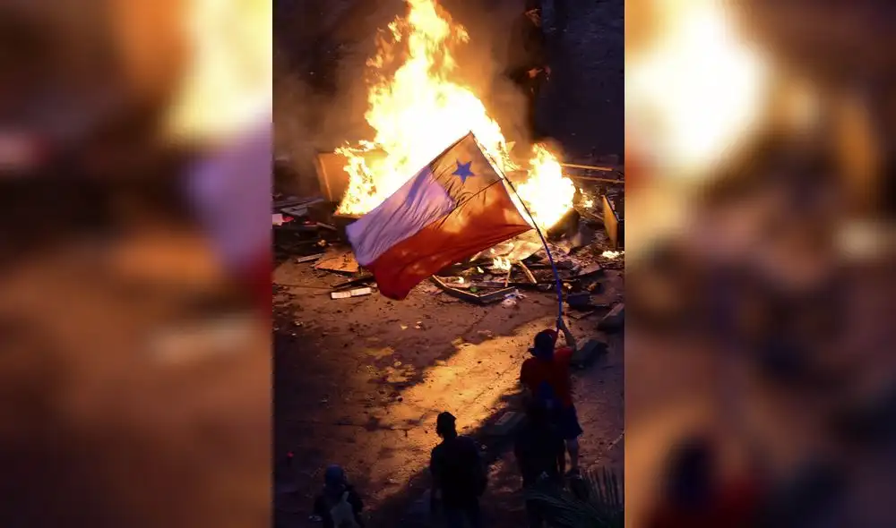 CHILE  ///  SIGUE  LAS PROTESTAS EN CHILE  EL  08 DE NOVIEMBRE DEL  2019 CON NUEVA MARCHA MASIVA EN SANTIAGO  CON INCIDENTES  , INCENDIO DE  UNA UNIVERSIDAD PARTICULAR  Y SAQUEOS ESTAS  MANIFESTACIONES  SE INICIARON  EL 18 DE OCTUBRE DEL  2019  TRAS  EL AUMENTO  DE LOS PASAJES EN EL METRO DECRETADO POR EL GOBIERNO A PESAR QUE  DESPUES  ANULO  DICHO INCREMENTO  PERO LAS  PROTESTAS  SIGUIERON HASTA  HOY  08 DE NOVIEMBRE   2019    Aerial view of people demonstrating with a Chilean national flag next to a bonfire against the government of Chilean President Sebastian Pinera in Santiago, on November 8, 2019. - Unrest began in Chile last October 18 with protests against a rise in transport tickets and other austerity measures that descended into vandalism, looting, and clashes between demonstrators and police. (Photo by Martin BERNETTI / AFP)
