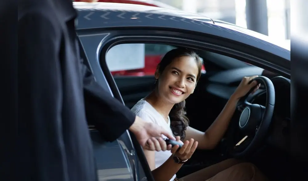 Beautiful asian woman buying a car at the showroom