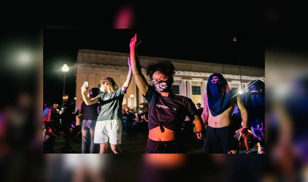 KENOSHA, WI - AUGUST 25: Demonstrators raise their fist in the air, in front of law enforcement, on August 25, 2020 in Kenosha, Wisconsin. As the city declared a state of emergency curfew, a third night of civil unrest occurred after the shooting of Jacob Blake, 29, on August 23. Video shot of the incident appears to show Blake shot multiple times in the back by Wisconsin police officers while attempting to enter the drivers side of a vehicle. The 29-year-old Blake was undergoing surgery for a severed spinal cord, shattered vertebrae and severe damage to organs, according to the family attorneys in published accounts.   Brandon Bell/Getty Images/AFP