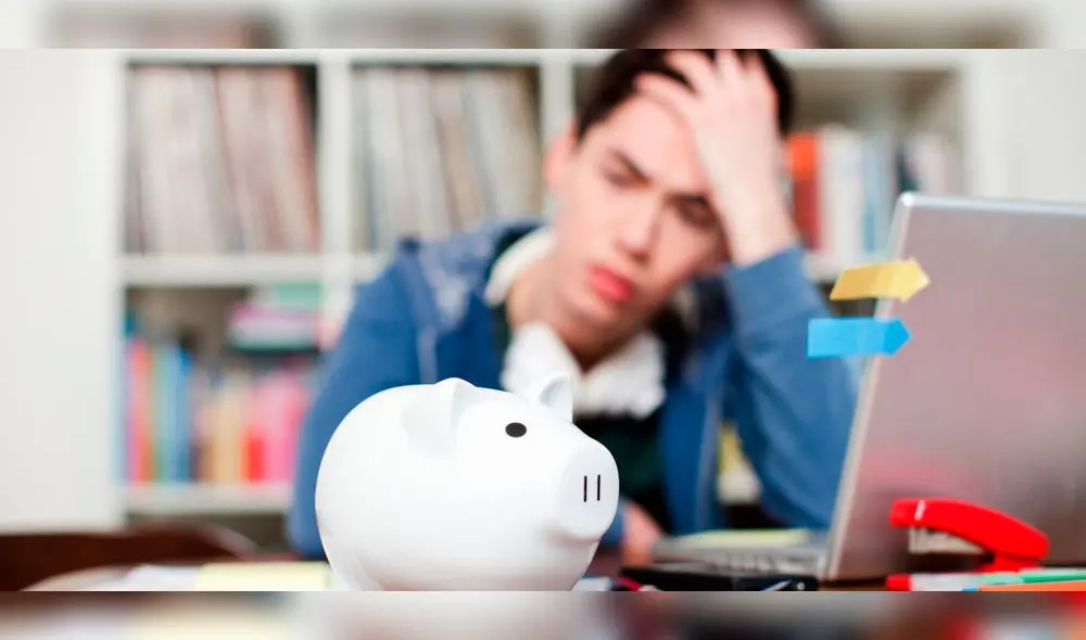 Piggy bank with young man worrying in background Piggy bank with young man worrying in background