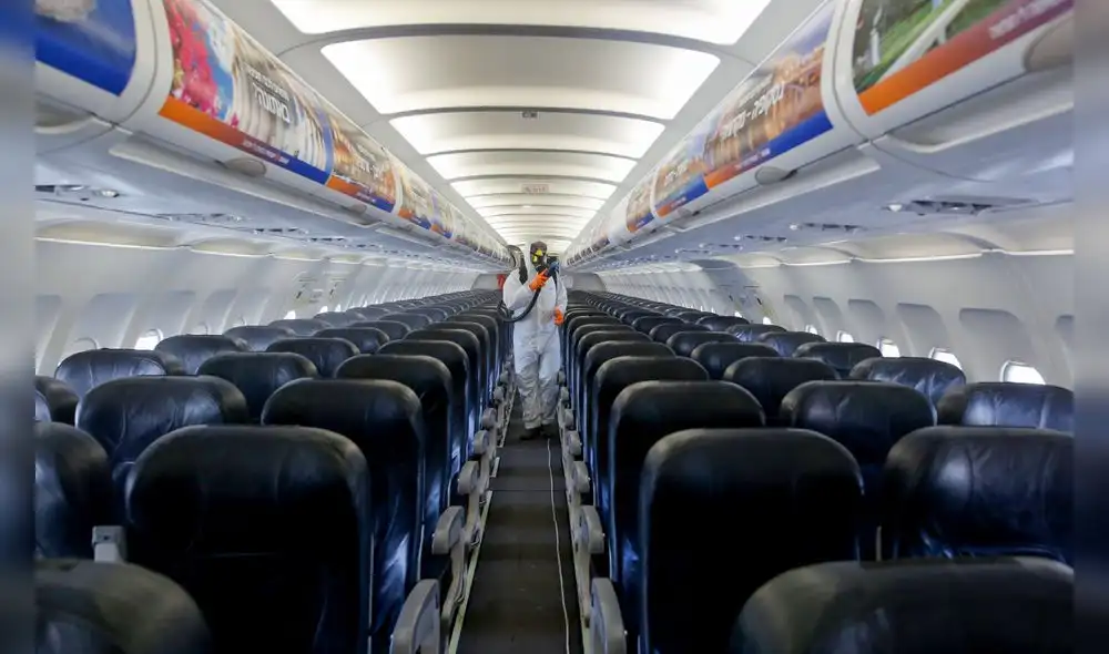 An Israeli worker in full hazmat suit sprays disinfectant in the cabin of an Israir Airlines Airbus A320 airplane, at the Ben Gurion International Airport near the central Israeli city of Tel Aviv, on June 14, 2020, amid the novel coronavirus pandemic. (Photo by GIL COHEN-MAGEN / AFP) An Israeli worker in full hazmat suit sprays disinfectant in the cabin of an Israir Airlines Airbus A320 airplane, at the Ben Gurion International Airport near the central Israeli city of Tel Aviv, on June 14, 2020, amid the novel coronavirus pandemic. (Photo by GIL COHEN-MAGEN / AFP)