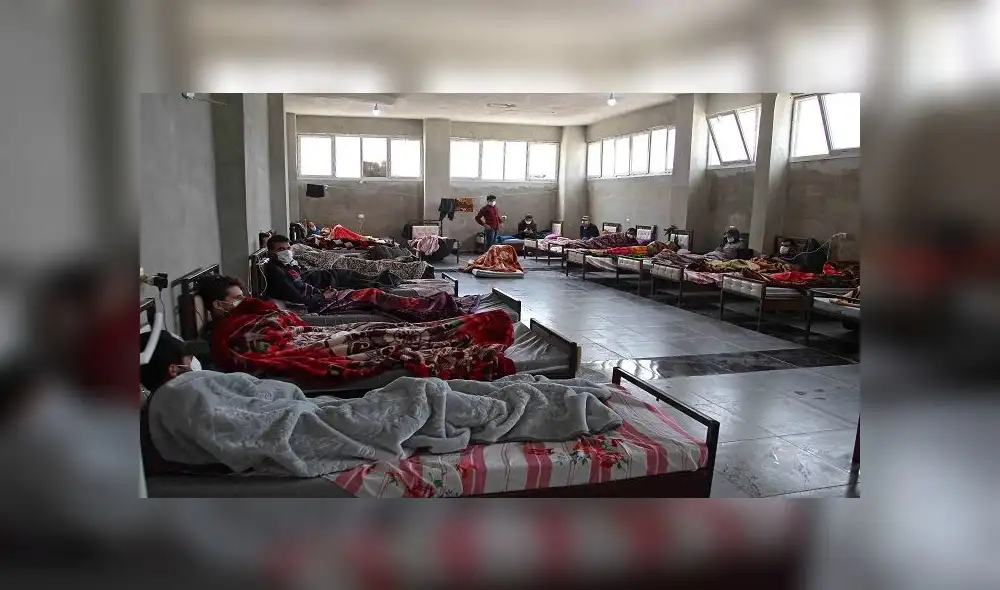 Syrians who returned from Turkey rest at a quarantine facility in the countryside of the town of Jisr al-Shughur, west of the mostly rebel-held Syrian province of Idlib, on April 27, 2020 amid the coronavirus COVID-19 pandemic. (Photo by Abdulaziz KETAZ / AFP)