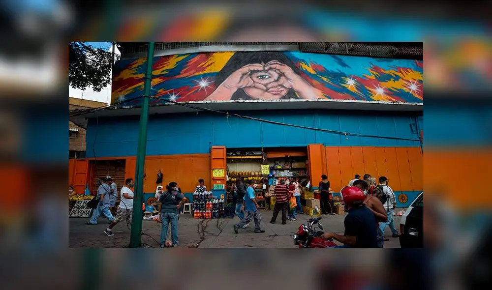 Varias personas caminan por una calle comercial el martes 25 de agosto en Caracas (Venezuela). Foto: EFE