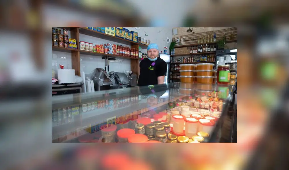 Cijay Brightman poses for a photo in Tel Aviv, Israel, Monday, July 13, 2020. A year ago, Brightman was doing sound and lighting for a Madonna performance in Israel. Now, after the coronavirus wiped out live events, he's making sandwiches, slicing cheese and serving customers at a Tel Aviv deli. (AP Photo/Sebastian Scheiner)