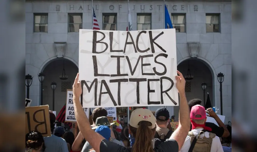Supporters of Black Lives Matter, hold signs during a protest outside the Hall of Justice as they demonstrate against the death of George Floyd, in Los Angeles, California on June 10, 2020. (Photo by Mark RALSTON / AFP)