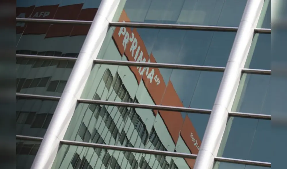 The Prima AFP (Pension Fund Administration) building is reflected on a window in Lima on May 18, 2020. - More than six million Peruvians can request as of Monday the withdrawal of up to 3,700 US dollars from their pension funds to alleviate the economic crisis caused during the two months lockdown imposed by the government to fight the spread of the novel Covid-19 coronavirus. (Photo by ERNESTO BENAVIDES / AFP)