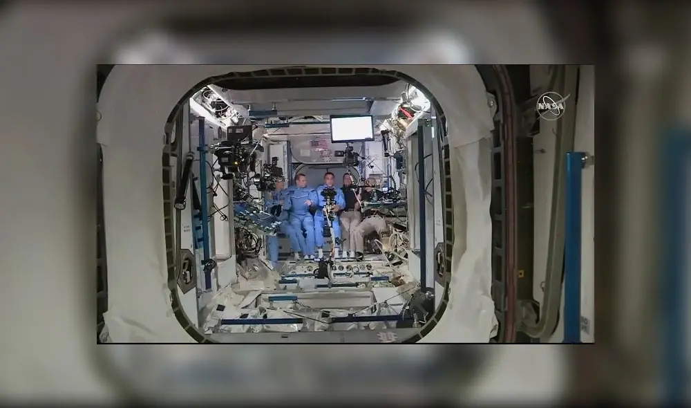 This NASA video frame grab image shows NASA SpaceX�s Crew Dragon astronauts Douglas Hurley(R) and Robert Behnken(2ndR) arriving after the hatch opened to the International Space Station, posing with other astronauts on May 31, 2020. - US astronauts on a SpaceX Crew Dragon capsule were completing final close out procedures before entering the International Space Station after the hatch was opened between the two vessels. The hatch opened at 1:02 pm Eastern Time (1702 GMT) as Bob Behnken and Doug Hurley were poised to cross over into the station, the first US astronauts to arrive on an American spacecraft in nine years. (Photo by Handout / NASA TV / AFP) / RESTRICTED TO EDITORIAL USE - MANDATORY CREDIT "AFP PHOTO /NASA TV/HANDOUT " - NO MARKETING - NO ADVERTISING CAMPAIGNS - DISTRIBUTED AS A SERVICE TO CLIENTS