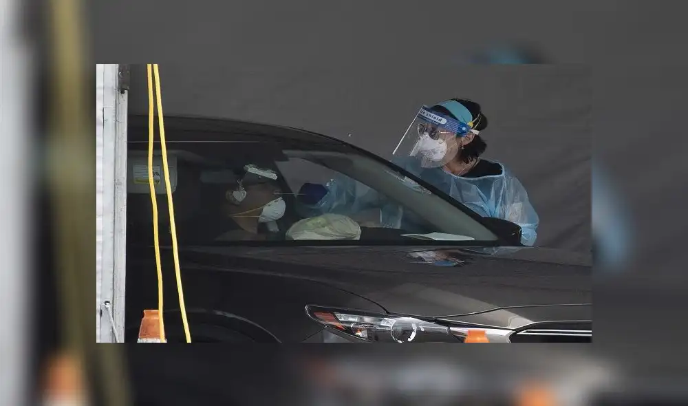 MIAMI GARDENS, FLORIDA - JULY 13: A health care worker tests a person for COVID-19 at the COVID test site located in the Hard Rock Stadium parking lot on July 13, 2020 in Miami Gardens, Florida. Florida health officials on Sunday reported 15,300 new confirmed cases of COVID-19 as the state of Florida tries to contain the recent spike in cases. Joe Raedle/Getty Images/AFP MIAMI GARDENS, FLORIDA - JULY 13: A health care worker tests a person for COVID-19 at the COVID test site located in the Hard Rock Stadium parking lot on July 13, 2020 in Miami Gardens, Florida. Florida health officials on Sunday reported 15,300 new confirmed cases of COVID-19 as the state of Florida tries to contain the recent spike in cases. Joe Raedle/Getty Images/AFP
