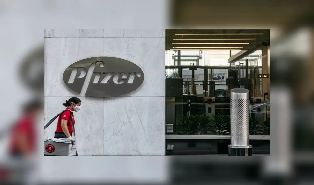 NEW YORK, NY - JULY 22: A pedestrian wearing a protective mask walks past Pfizer Inc. headquarters on July 22, 2020 in New York City. Pfizer and German biotechnology firm BioNTech have agreed to supply the U.S. government with 100 million doses of coronavirus vaccine under a $1.95 billion deal.   Jeenah Moon/Getty Images/AFP
