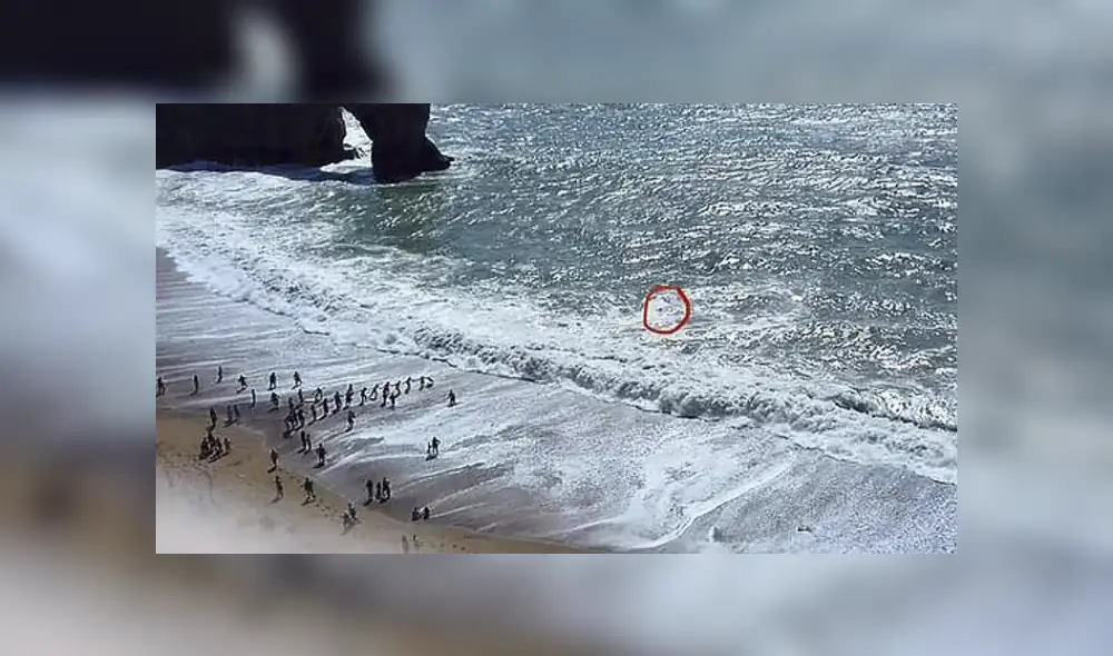 El hombre logró sobrevivir gracias a la cadena humana que armaron los bañistas que estaban en la orilla. Foto: Richard Markham El hombre logró sobrevivir gracias a la cadena humana que armaron los bañistas que estaban en la orilla. Foto: Richard Markham