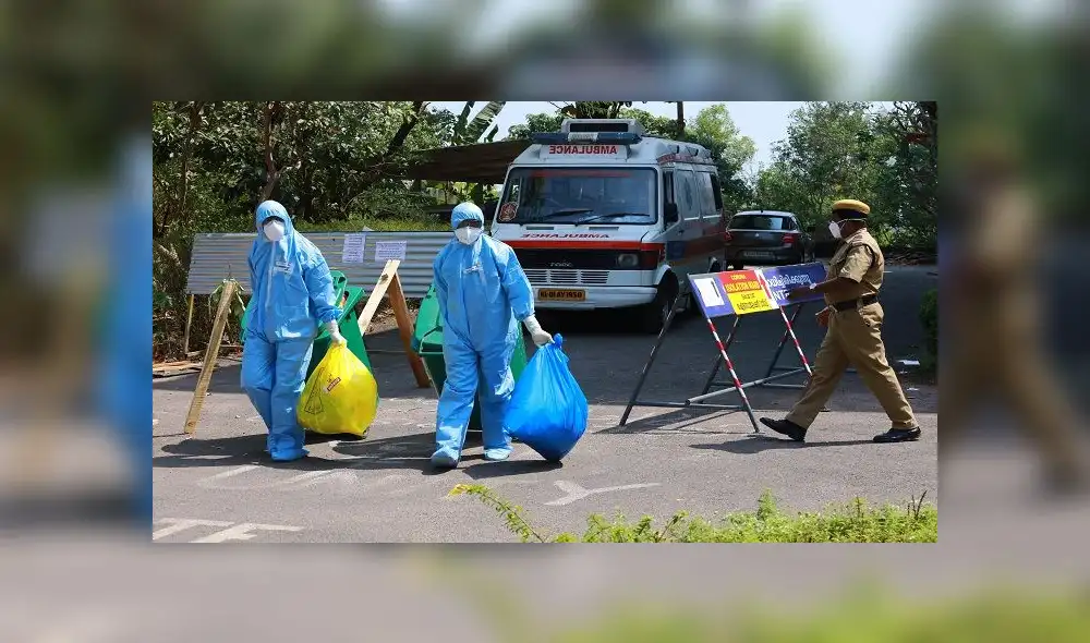 Heath officials in full protective apparel carry medical waste out of an isolation ward of Ernakulam medical, where 12 suspected SARS-like virus patients are kept in quaratine, in Kochi on February 4, 2020. - The new coronavirus that emerged in a Chinese market at the end of last year has killed more than 360 people and spread around the world. (Photo by Arun CHANDRABOSE / AFP)