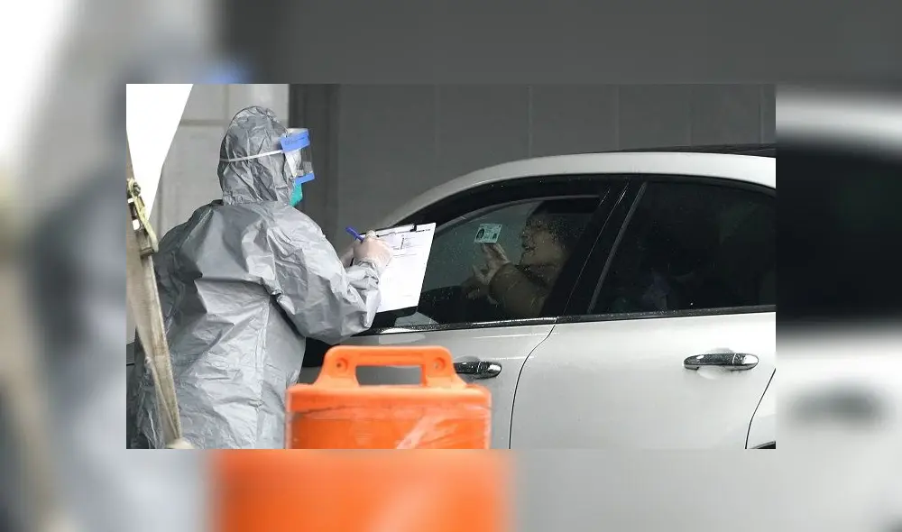 Workers in protective suits check id's of patients as they arrive by car to be tested for Coronavirus (COVID-19) at the State's First Drive Through COVID-19 Mobile Testing Center at Glen Island Park in New Rochelle, New York March 13, 2020. - Governor Andrew M. Cuomo on March 13, 2020 opened the state�s first drive-through COVID-19 mobile testing center in New Rochelle. (Photo by TIMOTHY A. CLARY / AFP) Workers in protective suits check id's of patients as they arrive by car to be tested for Coronavirus (COVID-19) at the State's First Drive Through COVID-19 Mobile Testing Center at Glen Island Park in New Rochelle, New York March 13, 2020. - Governor Andrew M. Cuomo on March 13, 2020 opened the state�s first drive-through COVID-19 mobile testing center in New Rochelle. (Photo by TIMOTHY A. CLARY / AFP)