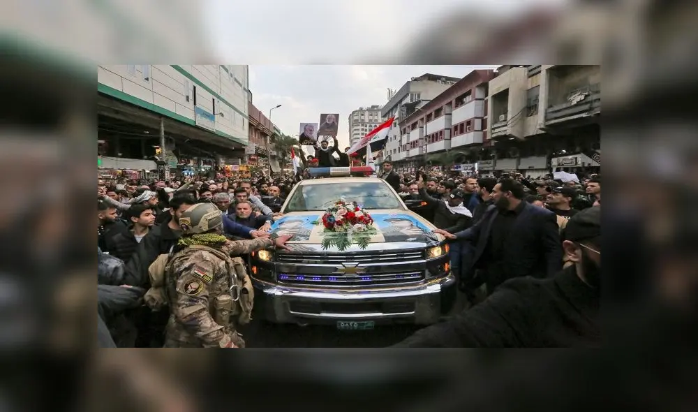 Mourners surround a car carrying the coffins of Iranian military commander Qasem Soleimani and Iraqi paramilitary chief Abu Mahdi al-Muhandis, killed in a US air strike, during their funeral procession in Kadhimiya, a Shiite pilgrimage district of Baghdad, on January 4, 2020. - Thousands of Iraqis chanting "Death to America" joined the funeral procession Saturday for Iranian commander Qassem Soleimani and Iraqi paramilitary chief Abu Mahdi al-Muhandis, both killed in a US air strike. The cortege set off around Kadhimiya, a Shiite pilgrimage district of Baghdad, before heading to the Green Zone government and diplomatic district where a state funeral was to be held attended by top dignitaries. In all, 10 people -- five Iraqis and five Iranians -- were killed in Friday morning's US strike on their motorcade just outside Baghdad airport. (Photo by SABAH ARAR / AFP) Mourners surround a car carrying the coffins of Iranian military commander Qasem Soleimani and Iraqi paramilitary chief Abu Mahdi al-Muhandis, killed in a US air strike, during their funeral procession in Kadhimiya, a Shiite pilgrimage district of Baghdad, on January 4, 2020. - Thousands of Iraqis chanting "Death to America" joined the funeral procession Saturday for Iranian commander Qassem Soleimani and Iraqi paramilitary chief Abu Mahdi al-Muhandis, both killed in a US air strike. The cortege set off around Kadhimiya, a Shiite pilgrimage district of Baghdad, before heading to the Green Zone government and diplomatic district where a state funeral was to be held attended by top dignitaries. In all, 10 people -- five Iraqis and five Iranians -- were killed in Friday morning's US strike on their motorcade just outside Baghdad airport. (Photo by SABAH ARAR / AFP)