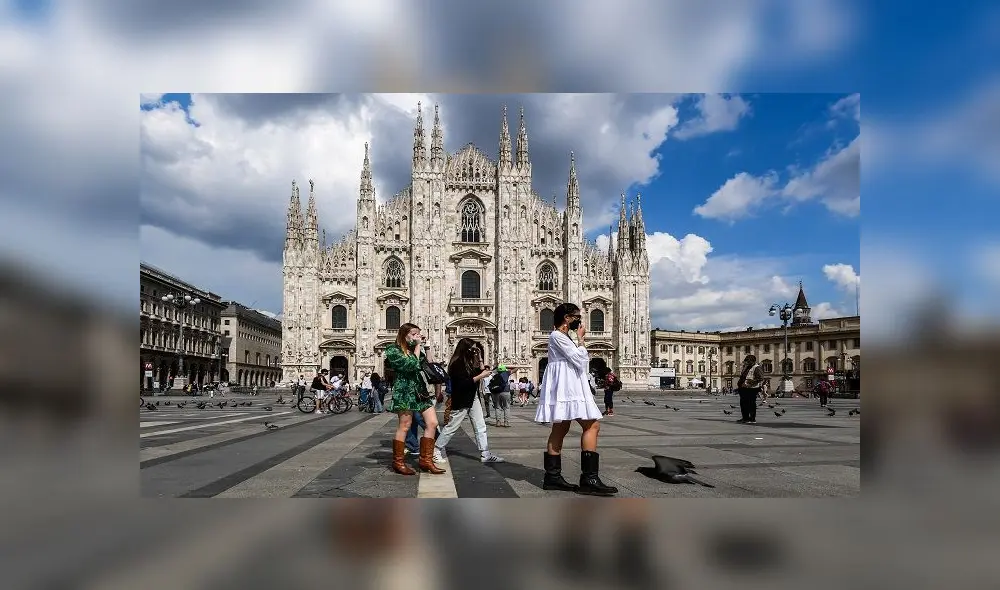 Young woman walk across Piazza del Duomo and the cathedral on June 3, 2020 in downtown Milan, as the country eases its lockdown aimed at curbing the spread of the COVID-19 infection, caused by the novel coronavirus. (Photo by Miguel MEDINA / AFP)