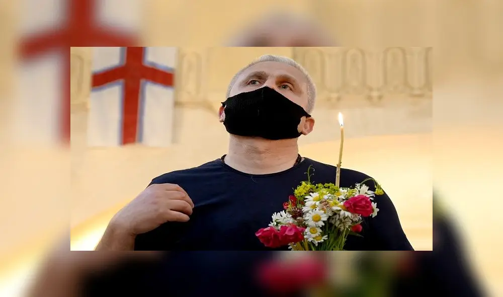 A Georgian Orthodox believer wearing a face mask attends a service celebrating Trinity Sunday in the Holy Trinity Cathedral in Tbilisi on June 7, 2020, as the country eases measures taken to curb the spread of the COVID-19 pandemic, caused by the novel coronavirus. (Photo by Vano SHLAMOV / AFP) A Georgian Orthodox believer wearing a face mask attends a service celebrating Trinity Sunday in the Holy Trinity Cathedral in Tbilisi on June 7, 2020, as the country eases measures taken to curb the spread of the COVID-19 pandemic, caused by the novel coronavirus. (Photo by Vano SHLAMOV / AFP)