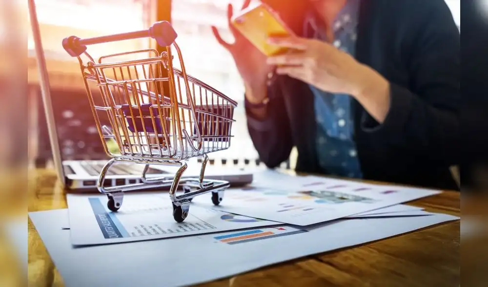 Cropped image of woman inputting card information and key on phone or laptop while shopping online.