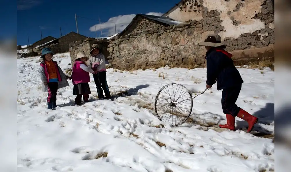 In this July 9, 2016 photo, children play after school in San Antonio de Putina in the Puno region of Peru. Two months into the cold season an estimated 14,000 children in the Andes have suffered from respiratory illnesses and 105 died, according to government figures. (AP Photo/Rodrigo Abd)