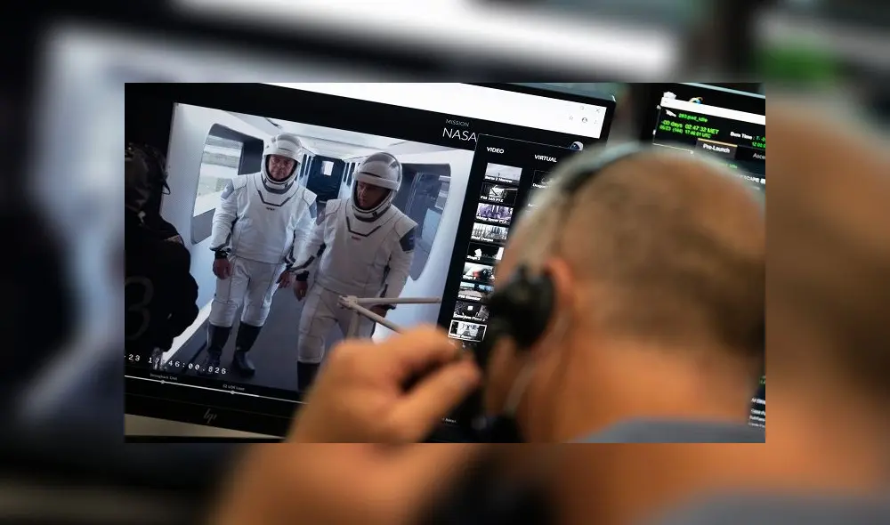 This handout photo released by NASA shows NASA astronauts Robert Behnken, left, and Douglas Hurley, right, are seen on a monitor showing the crew access arm at Launch Complex 39A during a dress rehearsal in preparation for the launch of a SpaceX Falcon 9 rocket carrying the company's Crew Dragon spacecraft on NASA�s SpaceX Demo-2 mission, Saturday, May 23, 2020, in firing room four of the Launch Control Center at NASA�s Kennedy Space Center in Florida. - NASA�s SpaceX Demo-2 mission is the first launch with astronauts of the SpaceX Crew Dragon spacecraft and Falcon 9 rocket to the International Space Station as part of the agency�s Commercial Crew Program. The test flight serves as an end-to-end demonstration of SpaceX�s crew transportation system. Behnken and Hurley are scheduled to launch at 4:33 p.m. EDT on Wednesday, May 27, from Launch Complex 39A at the Kennedy Space Center. A new era of human spaceflight is set to begin as American astronauts once again launch on an American rocket from American soil to low-Earth orbit for the first time since the conclusion of the Space Shuttle Program in 2011. (Photo by NASA/Joel Kowsky / NASA / AFP) / RESTRICTED TO EDITORIAL USE - MANDATORY CREDIT "AFP PHOTO /NASA/Joel Kowsky  " - NO MARKETING - NO ADVERTISING CAMPAIGNS - DISTRIBUTED AS A SERVICE TO CLIENTS