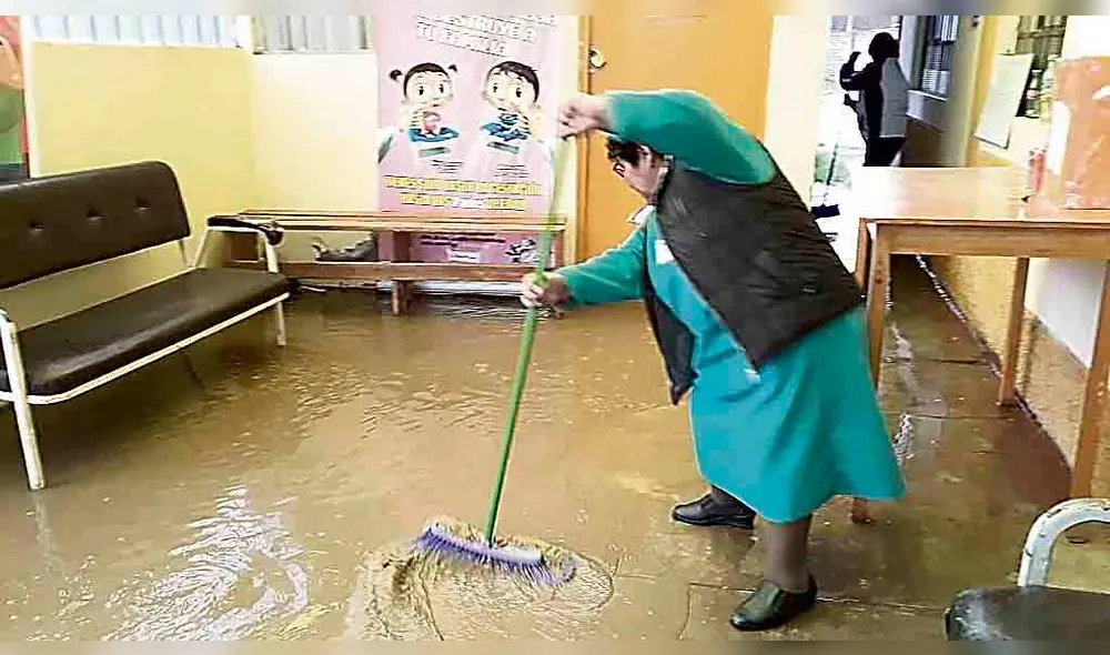 LIMPIEZA. Trabajadores tuvieron que sacar el agua del local. LIMPIEZA. Trabajadores tuvieron que sacar el agua del local.