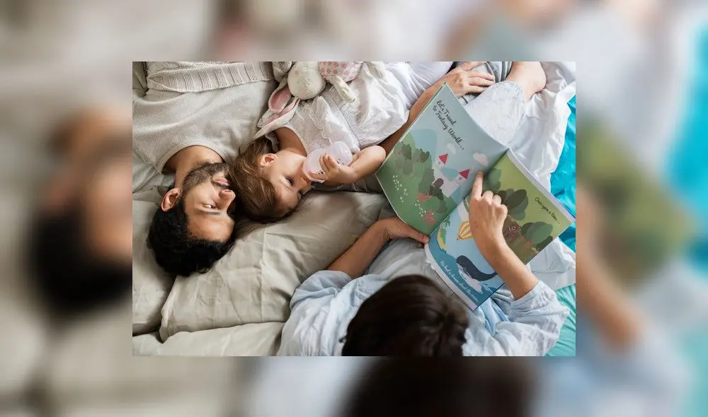 Caucasian family reading fairy tales to they daughter with happiness