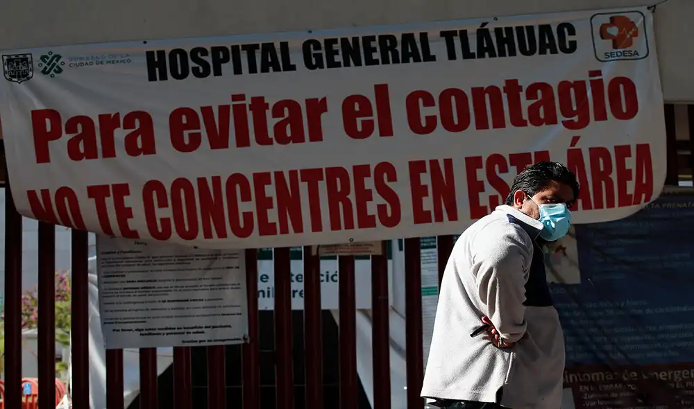 Un hombre frente a un letrero de advertencia de alto contagio de la COVID-19 en el Hospital General Tláhuac de Ciudad de México. Foto: EFE