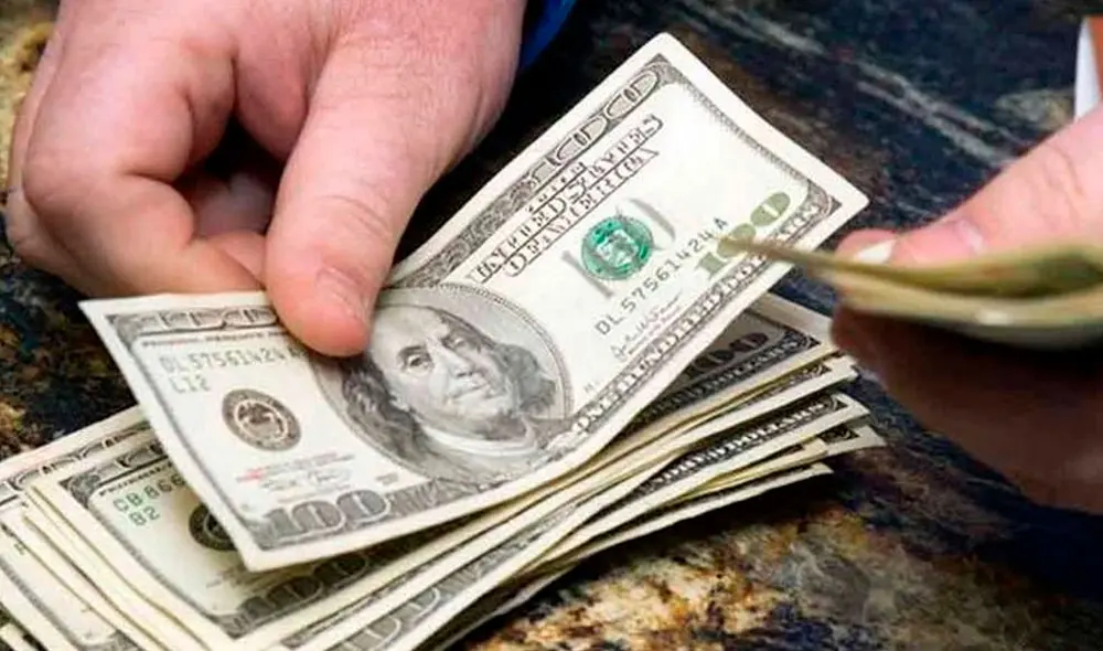 El precio del dólar oficial es chequeado tanto por compradores como por comerciantes. Foto: AFP El precio del dólar oficial es chequeado tanto por compradores como por comerciantes. Foto: AFP