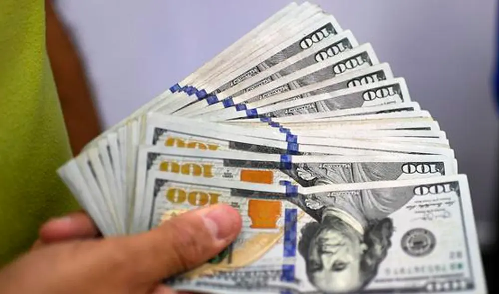 El precio del dólar oficial es revisado tanto por compradores como por comerciantes en Venezuela. Foto: AFP El precio del dólar oficial es revisado tanto por compradores como por comerciantes en Venezuela. Foto: AFP