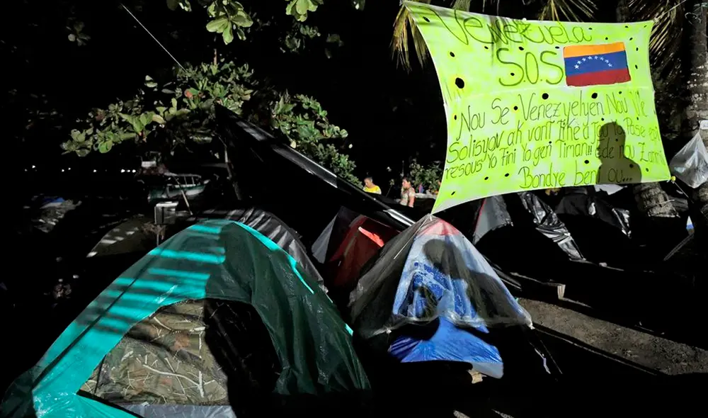Con la ayuda del traductor de Google, los venezolanos redactaron una pancarta que explica su situación. Foto: AFP Con la ayuda del traductor de Google, los venezolanos redactaron una pancarta que explica su situación. Foto: AFP