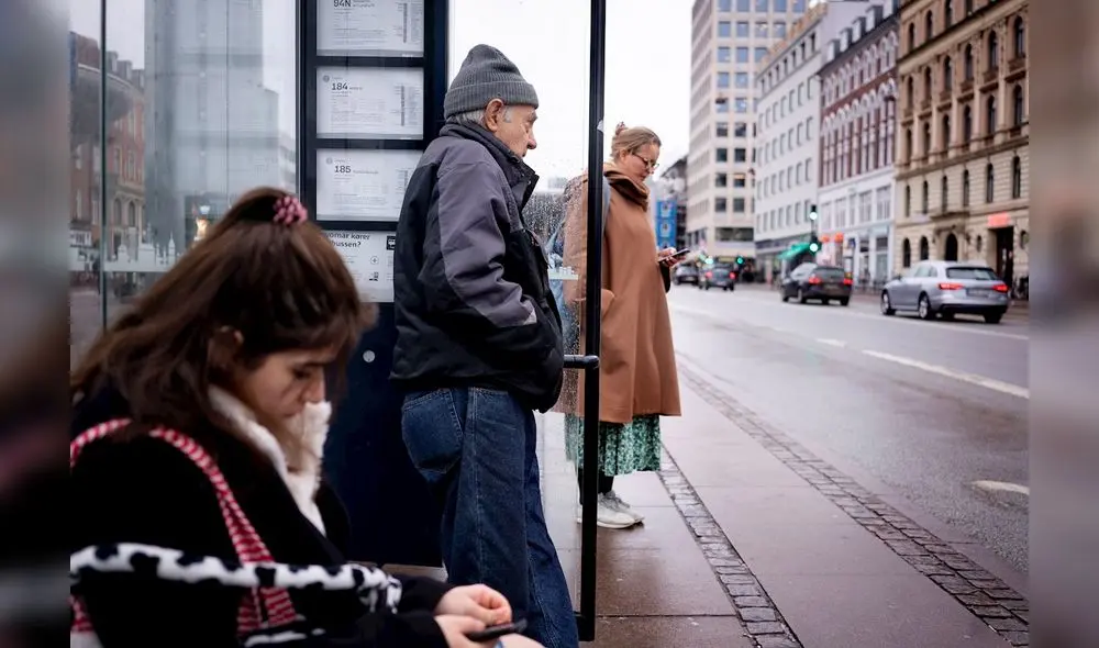 Los pasajeros esperan en una parada de autobús en Copenhague, Dinamarca, 01 de febrero de 2022. A partir de hoy, ya no es obligatorio llevar mascarilla protectora en cualquier lugar público de Dinamarca. Foto: EFE