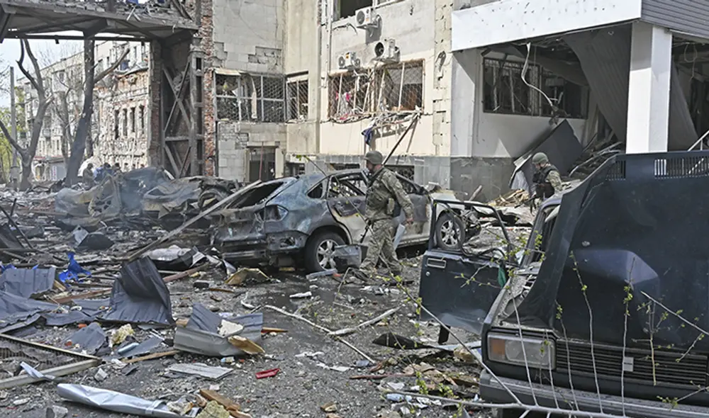 Un militar ucraniano pasa junto a vehículos destruidos cerca de edificios destruidos tras un bombardeo ruso. Foto: AFP Un militar ucraniano pasa junto a vehículos destruidos cerca de edificios destruidos tras un bombardeo ruso. Foto: AFP