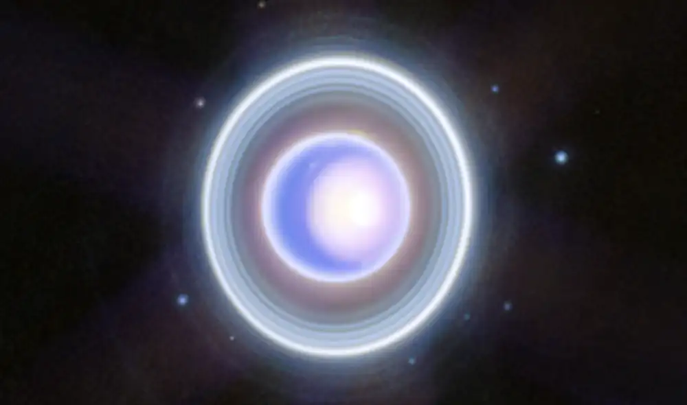 Astrónomos capturan con gran precisión el casquete polar norte estacional de Urano y sus tenues anillos interior y exterior. Foto: NASA, ESA, CSA, STScI