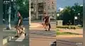 Joven es grabado al cargar a sus cachorros en la calle para evitar que corran en la pista