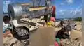 Jóvenes usan una máquina que separa la arena de la basura en la playa