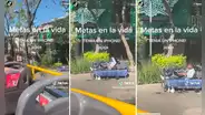 Turistas captan a hombre sin hogar utilizando laptop y celular en un parque