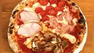 Este restaurante ofrece pizzas de manera ilimitada: ¿cuánto está la barra libre y dónde se ubica?
