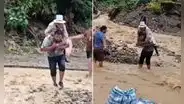 Adulta mayor es cargada para poder cruzar quebrada activa: lluvias intensas causan desborde de ríos en Madre de Dios