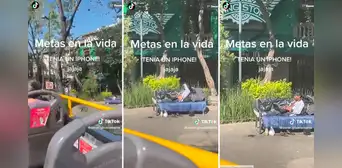 Turistas captan a hombre sin hogar utilizando laptop y celular en un parque Turistas captan a hombre sin hogar utilizando laptop y celular en un parque