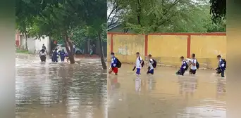 Escolares piuranos cruzan calles inundadas de agua y lluvias siguen afectando colegios