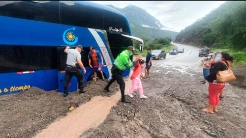 Policía ayudó a pasajeros de bus que quedó en medio de masa de lodo y piedra. Foto: PNP Pucará