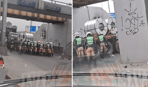 Policías intentan mover un tráiler con carga