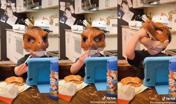 Niño intenta comer papas fritas con los dientes de su máscara de dinosaurio