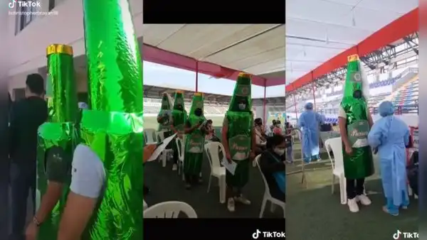 Peruanos asisten a vacunarse contra la COVID-19 vestidos de botellas de cerveza