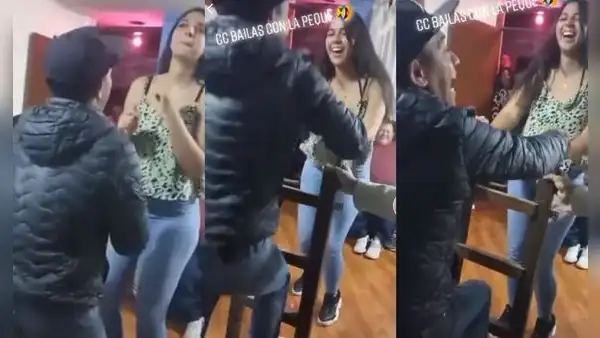 Hombre usa escalera durante una fiesta para bailar con una joven más alta que él