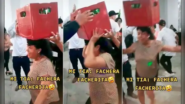 Mujer sorprende al bailar con una caja de cervezas sobre la cabeza sin que se caiga