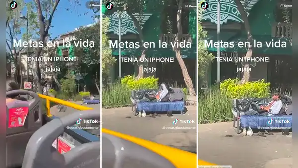 Turistas captan a hombre sin hogar utilizando laptop y celular en un parque
