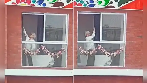 Adulta mayor baila marinera desde la ventana de su casa durante el Gran Desfile Militar