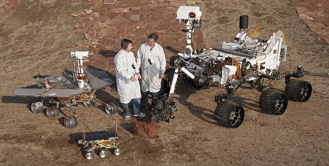 Dos ingenieros aparecen en el encuadre junto a Sojourner, Spirit (izquierda) y Oportunity (derecha) | Foto: NASA