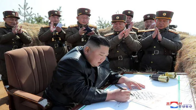 This picture taken on March 20, 2020 and released from North Korea's official Korean Central News Agency (KCNA) on March 21 shows North Korean leader Kim Jong Un (bottom) writing his congratulatory autograph on the master gunner certificate at an artillery fire competition between large combined units of the Korean People's Army (KPA) on the western front. (Photo by STR / KCNA VIA KNS / AFP) / - South Korea OUT / ---EDITORS NOTE--- RESTRICTED TO EDITORIAL USE - MANDATORY CREDIT "AFP PHOTO/KCNA VIA KNS" - NO MARKETING NO ADVERTISING CAMPAIGNS - DISTRIBUTED AS A SERVICE TO CLIENTS / THIS PICTURE WAS MADE AVAILABLE BY A THIRD PARTY. AFP CAN NOT INDEPENDENTLY VERIFY THE AUTHENTICITY, LOCATION, DATE AND CONTENT OF THIS IMAGE --- / 
