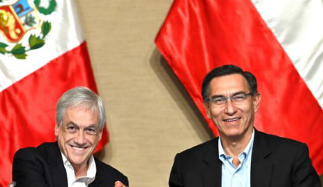 Peruvian President Martin Vizcarra (R) and his Chilean counterpart Sebastian Pinera shake hands after signing documents during a meeting in the framework of the Third Bi-national Peru-Chile Cabinet Meeting in the Peruvian port of Paracas, 260 km south of Lima, on October 10, 2019. (Photo by Cris BOURONCLE / AFP)