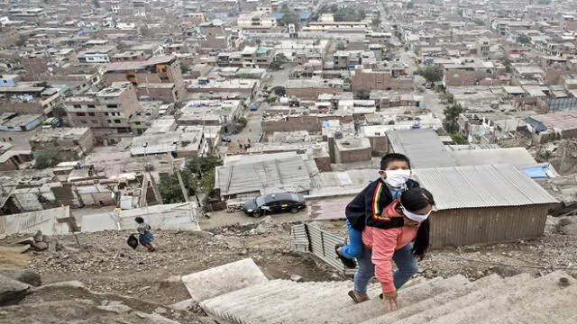 Peruvian Marlith Mori returns to her home on the heights of the Vista Alegre shantytown of the Comas district in the outskirts of Lima, carrying her impaired son Jeyson who attends daily therapy at a nearby medical facility, on May 21, 2020. - Mori lives in an area where residents' low budgets force them to break mandatory isolation to find daily means of support. Peru crossed the 100 thousand confirmed cases and statistics stand as of May 21 on 108,769 infected, of which 43,587 have recovered and 3,148 have died since the virus was first detected in Peru on March 6. (Photo by Geraldo Caso BIZAMA / AFP)